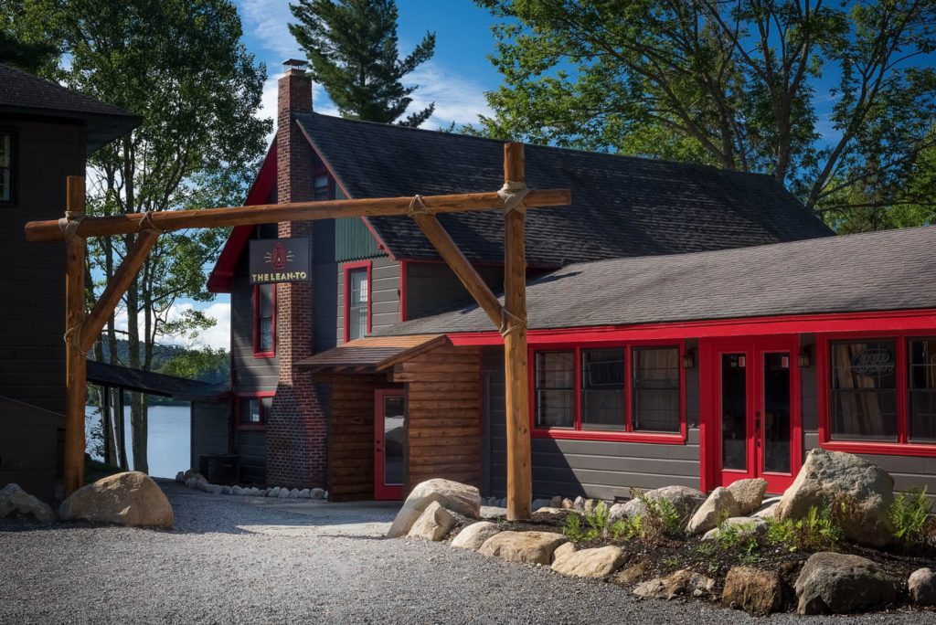 A house with a red roof and a wooden walkway.