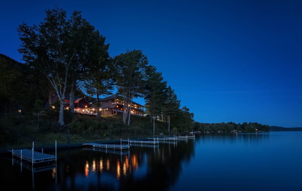A house on a lake at night.