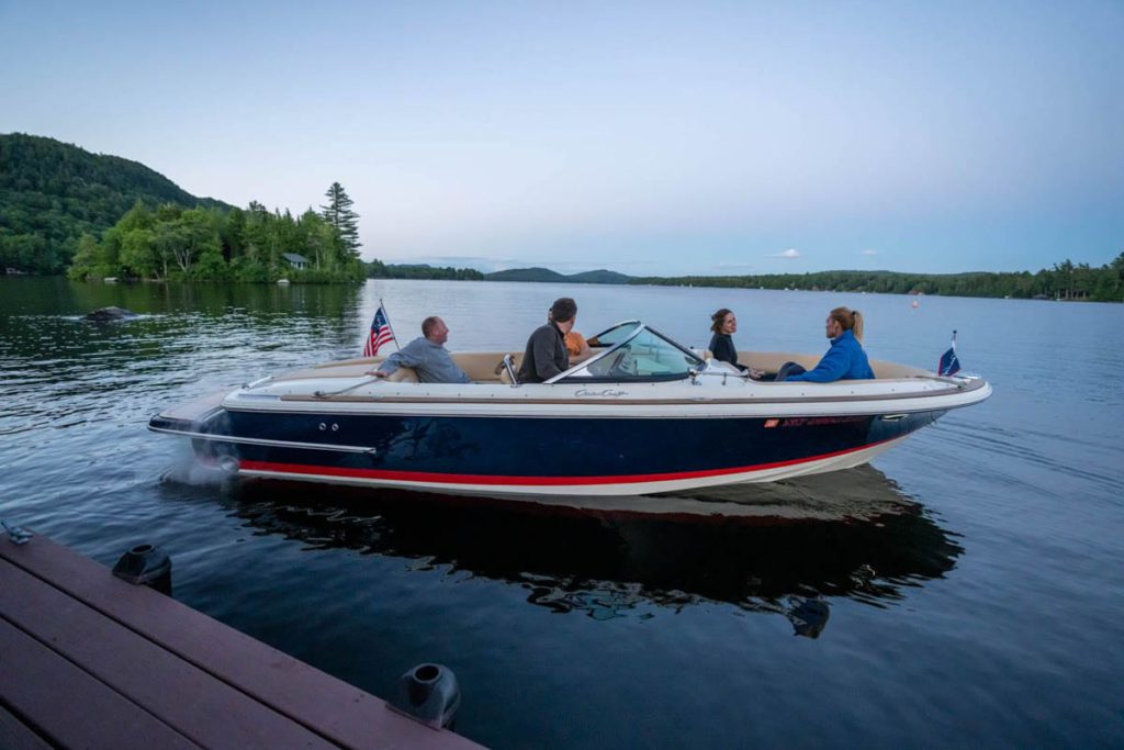 A group of people on a boat on a lake.