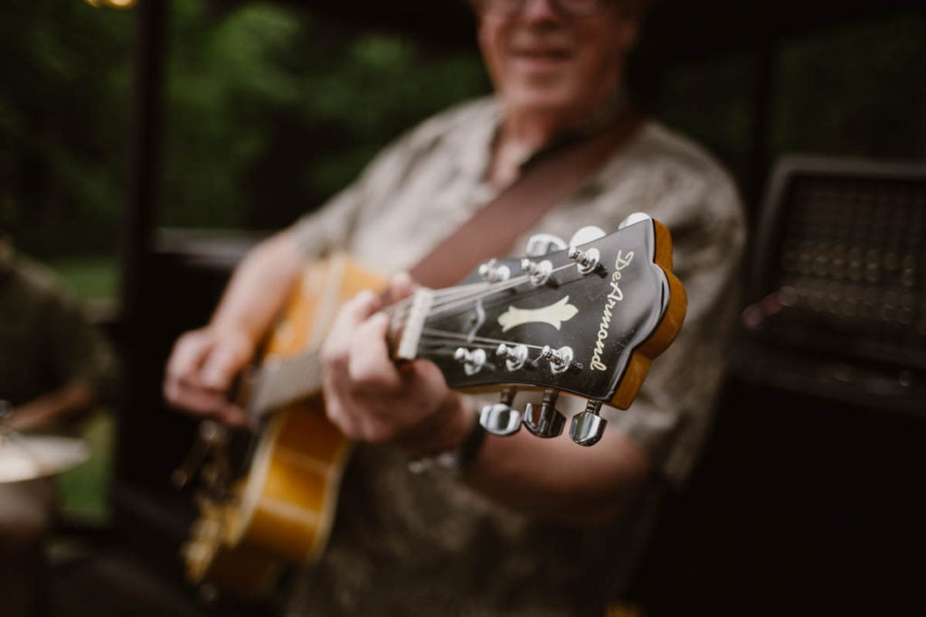 A man playing an acoustic guitar.