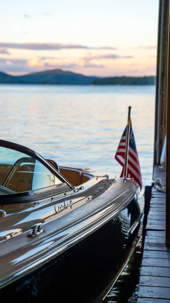 A boat docked at a dock with an american flag.