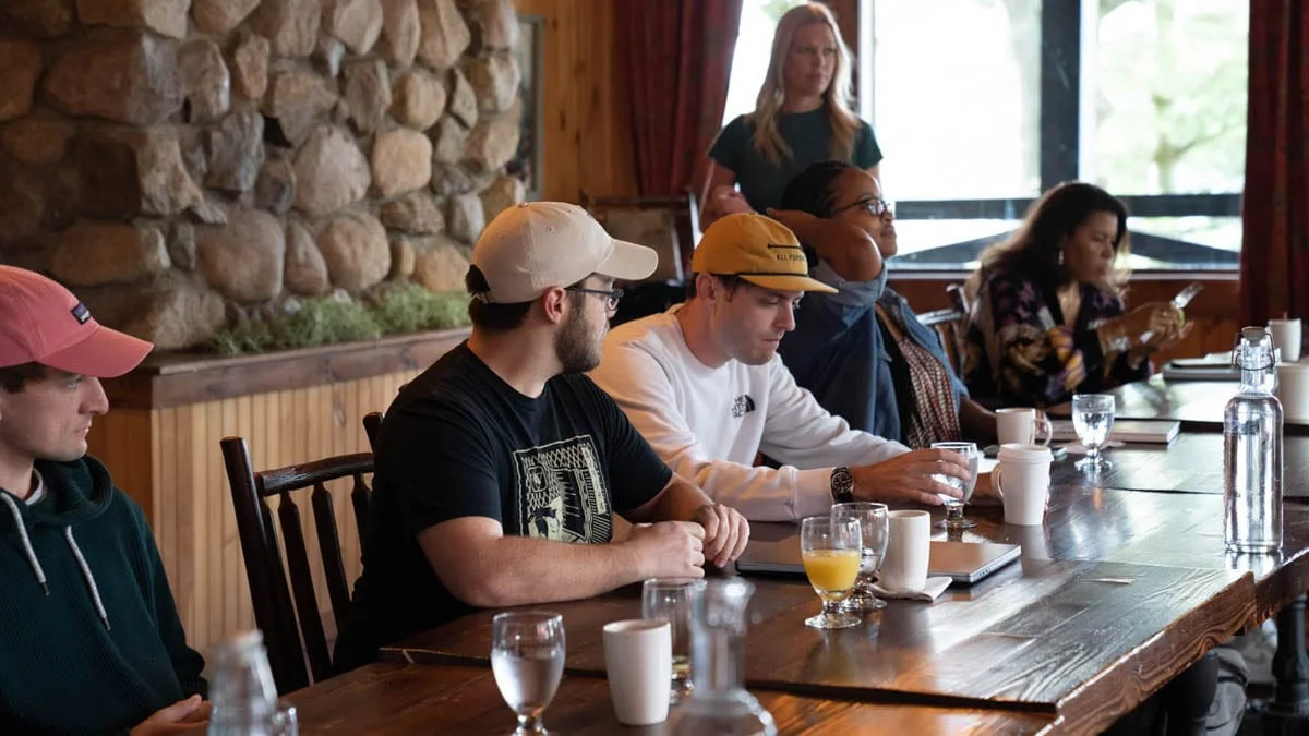 A group of people sitting at a long table.