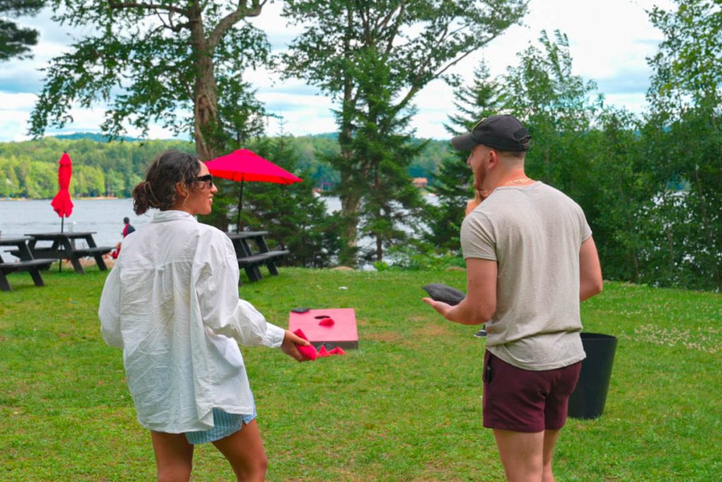 Two people standing in a grassy area with a frisbee in their hands.